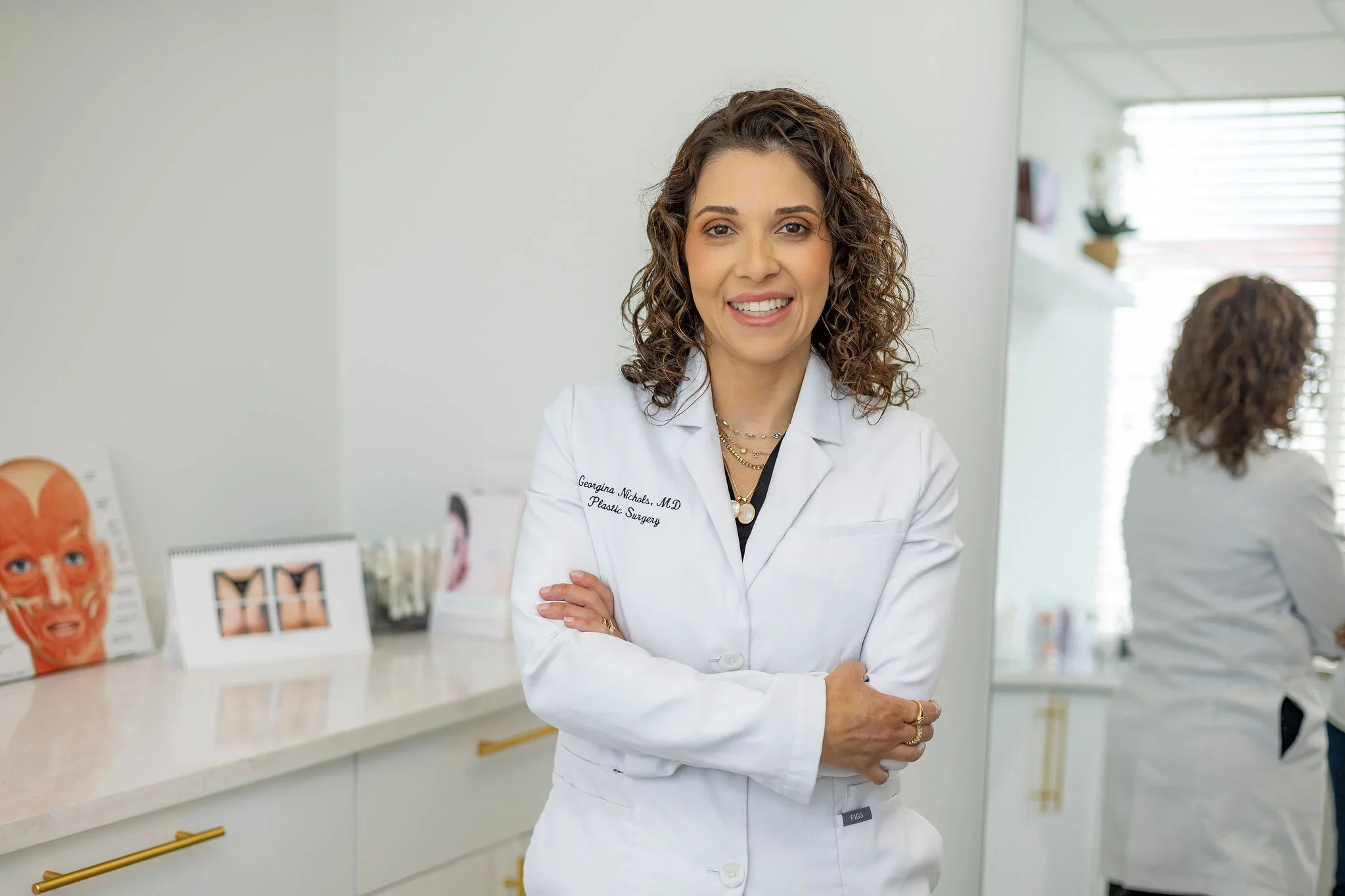 Dr. Georgina Nichols posing in a warmly lit clinic
